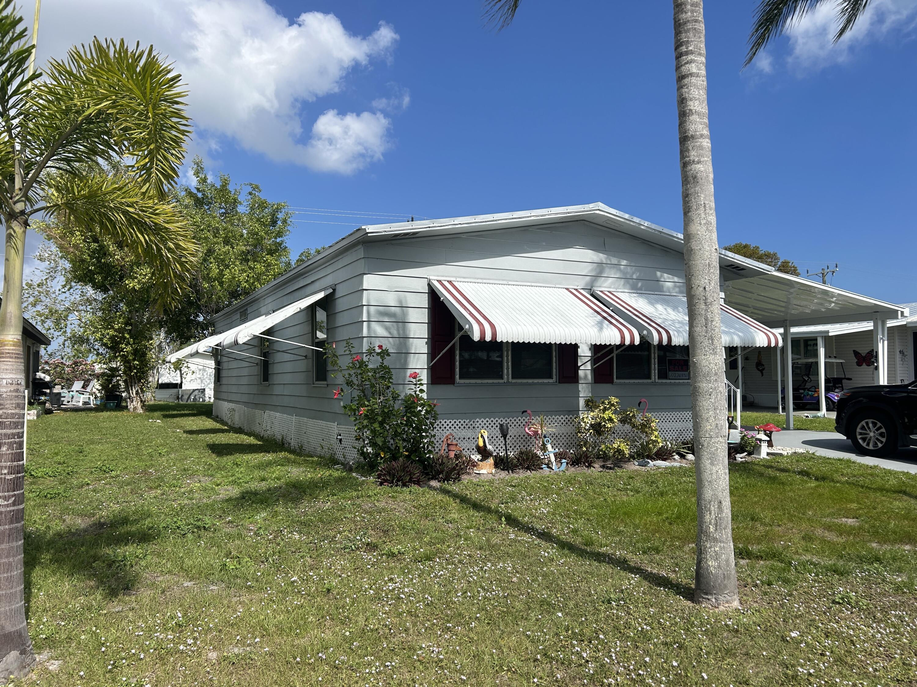 63 Ipanema Way Fort Pierce, FL 34951 - Photo 2 of 49 a front view of a house with a yard