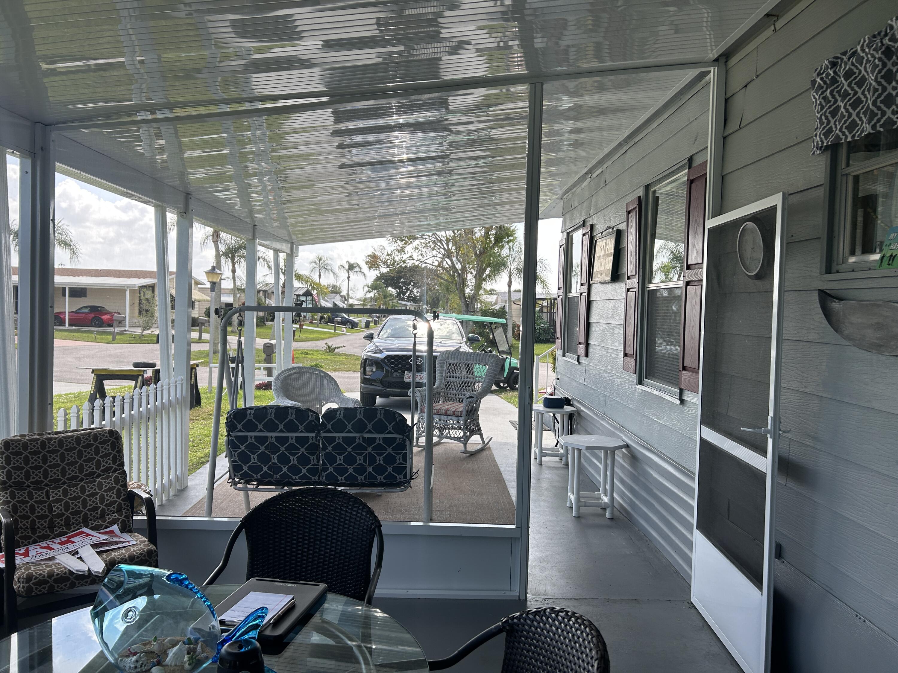 63 Ipanema Way Fort Pierce, FL 34951 - Photo 21 of 49 a living room with furniture and a floor to ceiling window