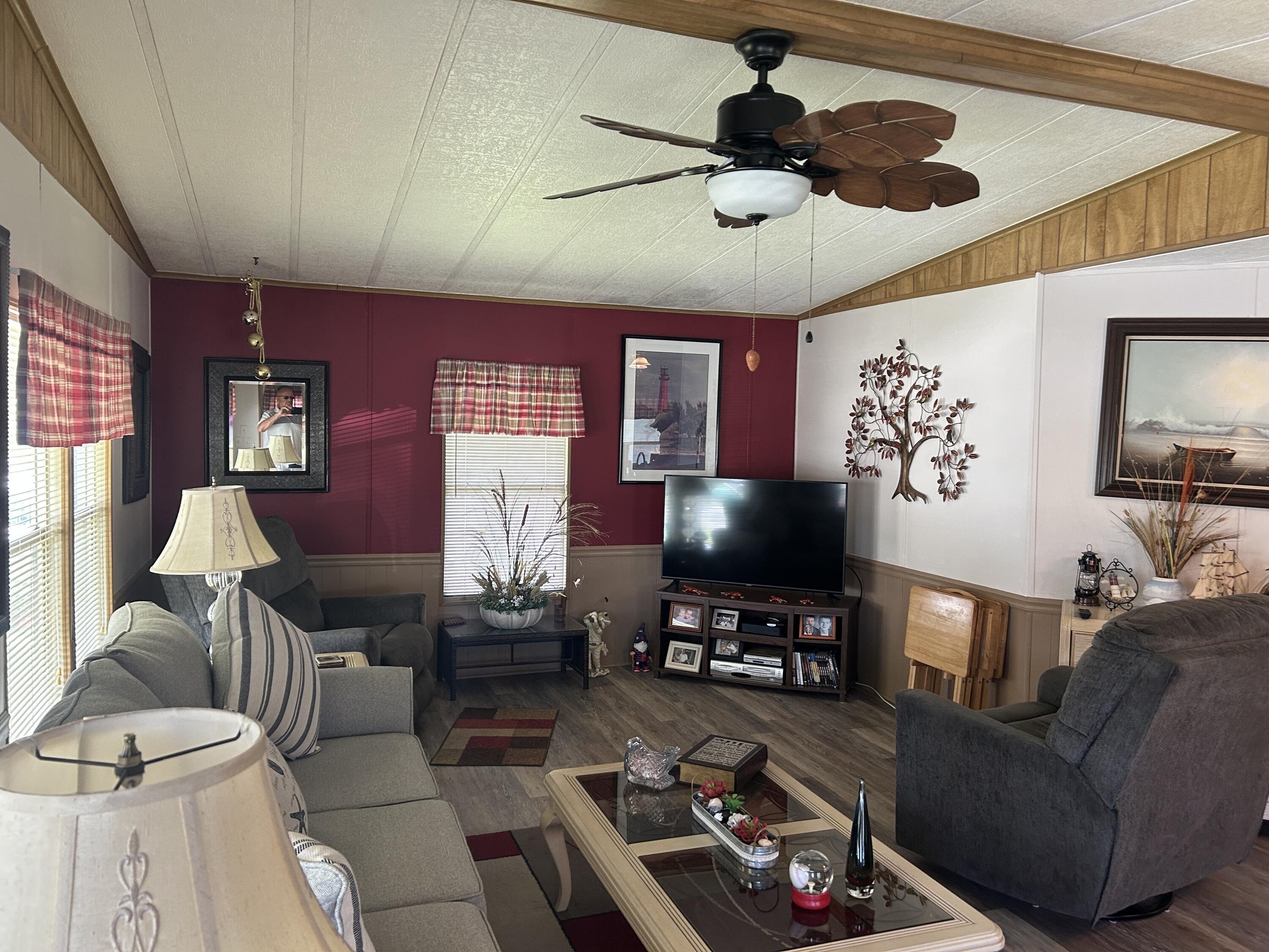 63 Ipanema Way Fort Pierce, FL 34951 - Photo 24 of 49 a living room with furniture and a flat screen tv