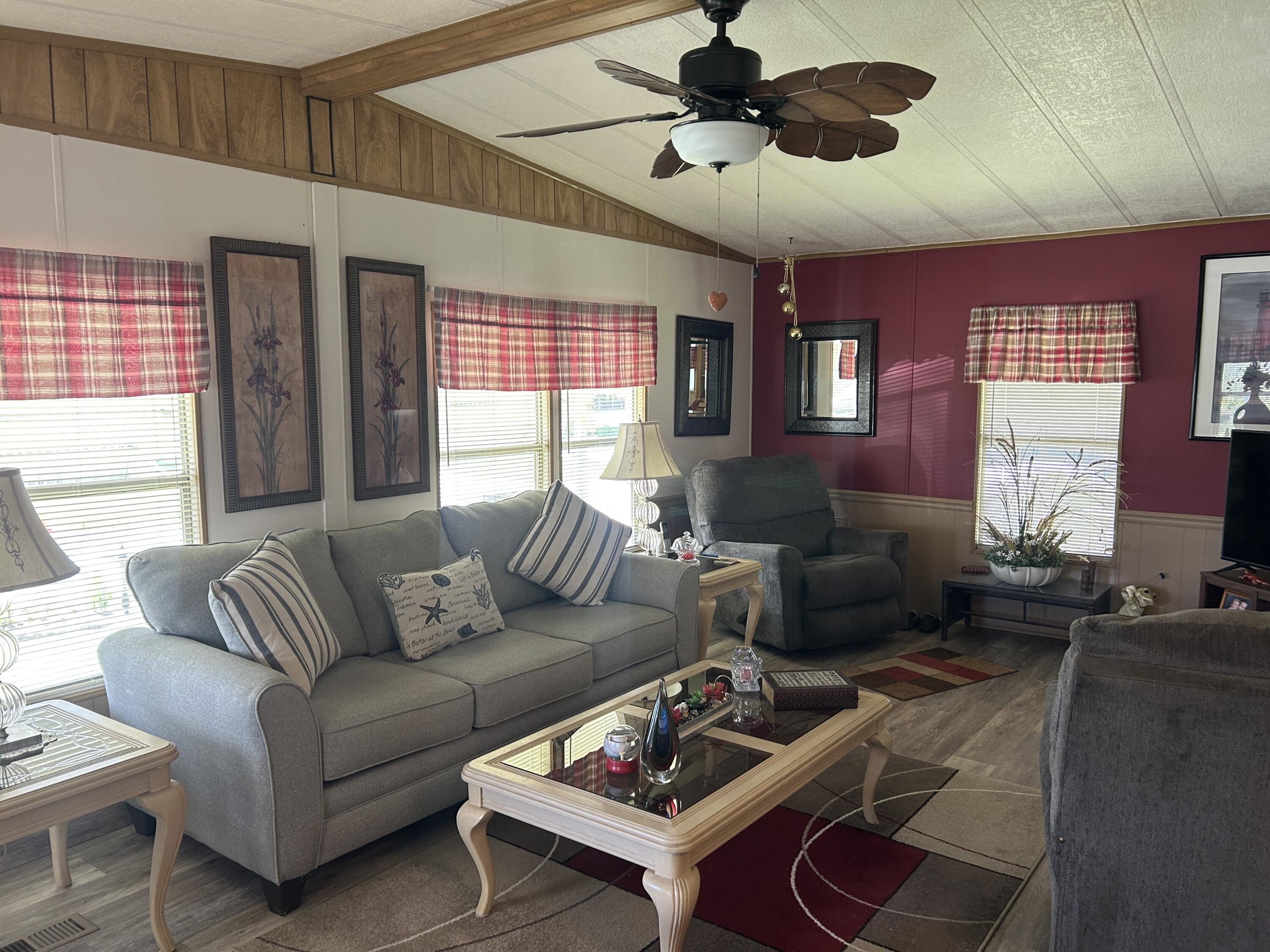 63 Ipanema Way Fort Pierce, FL 34951 - Photo 25 of 49 a living room with furniture ceiling fan and a window