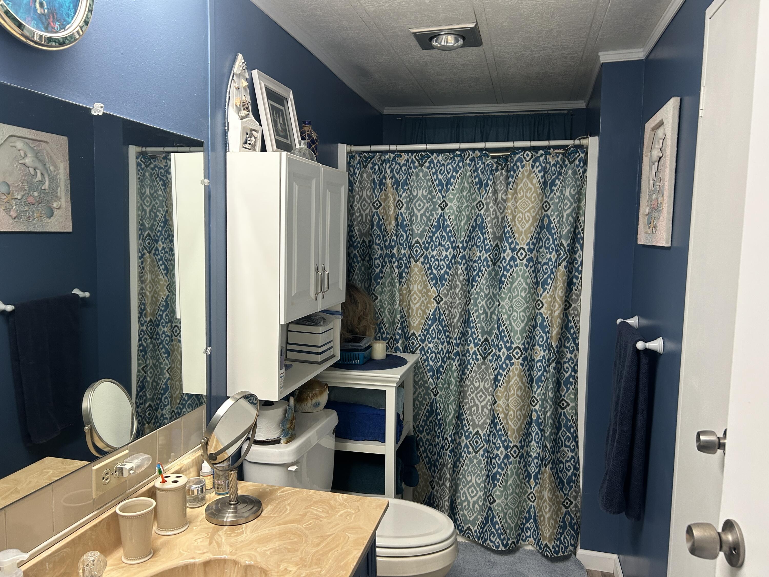 63 Ipanema Way Fort Pierce, FL 34951 - Photo 43 of 49 a bathroom with a sink a toilet and shower