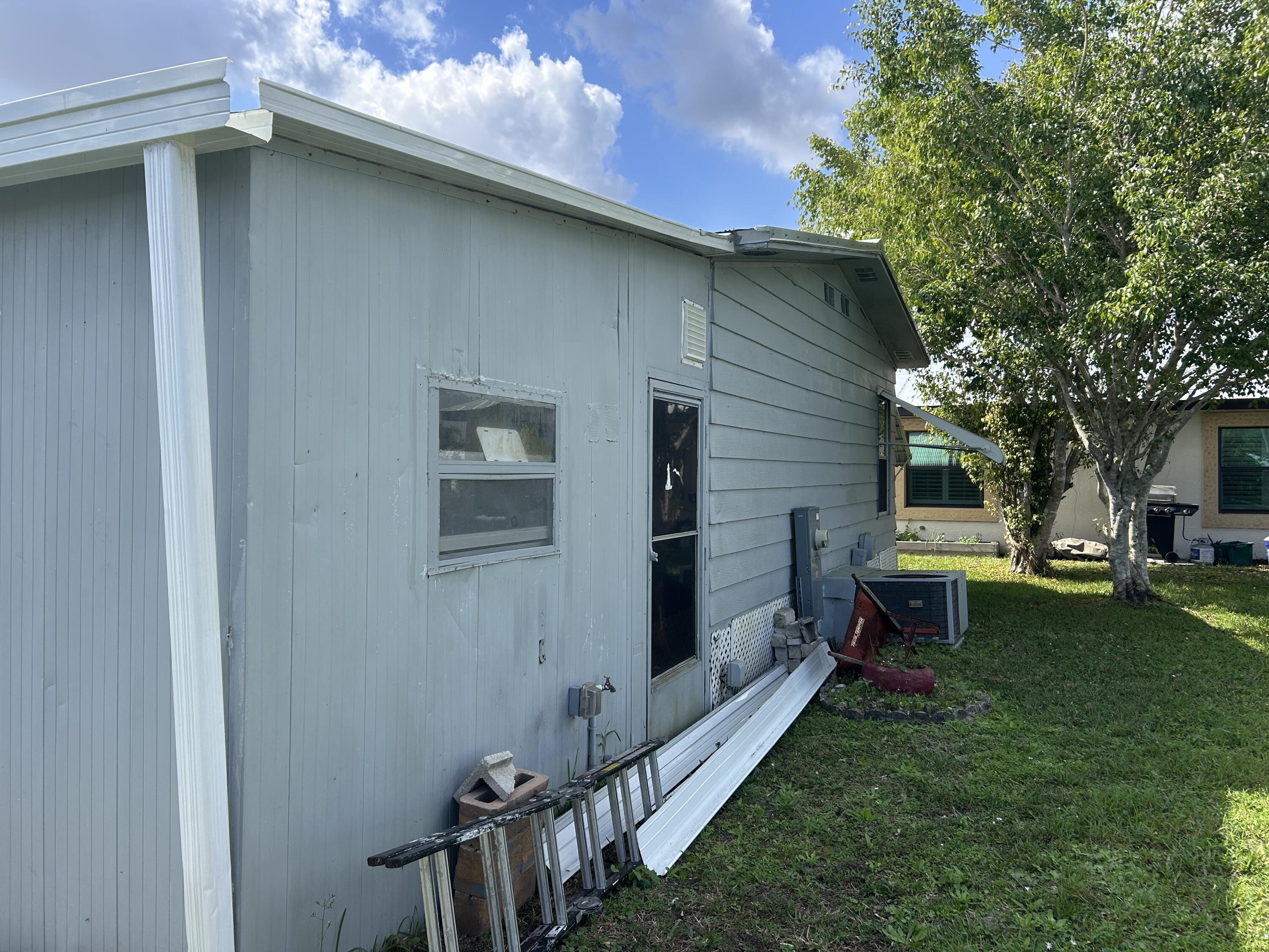 63 Ipanema Way Fort Pierce, FL 34951 - Photo 6 of 49 a backyard of a house with table and chairs