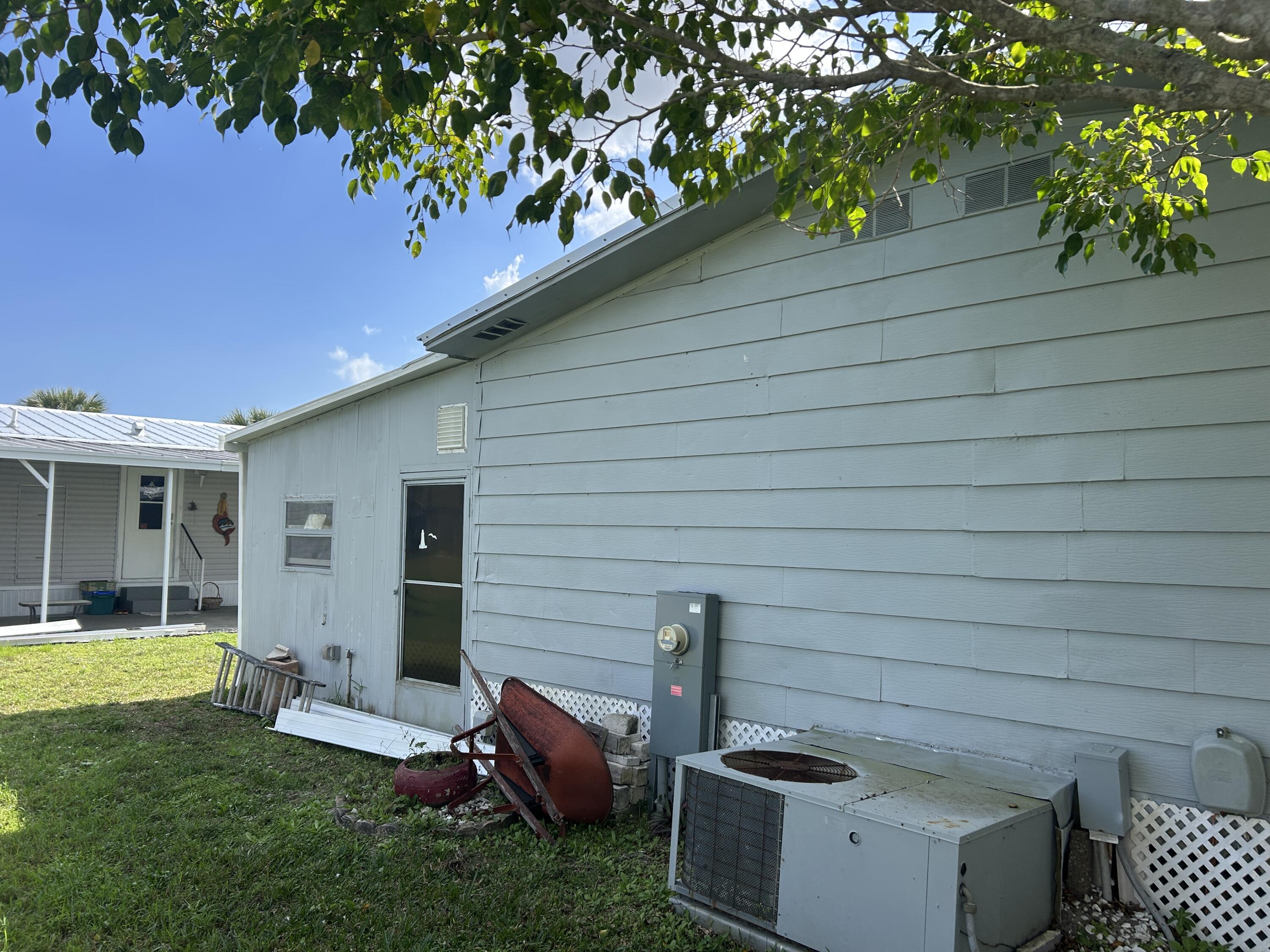 63 Ipanema Way Fort Pierce, FL 34951 - Photo 9 of 49 a view of a backyard with plants and a grill