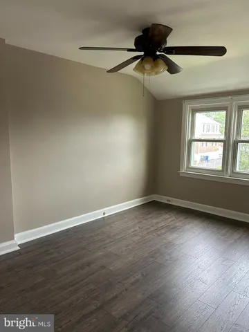 wooden floor that has a window in an empty room
