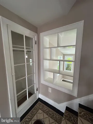 a room with walk in closet and a window