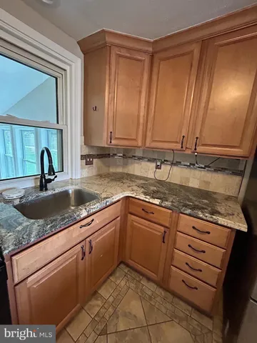 a kitchen with stainless steel appliances granite countertop a sink and cabinets