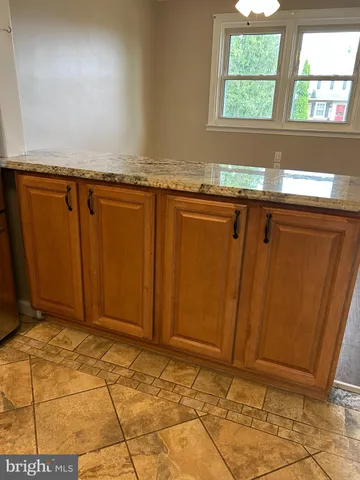 a view of a kitchen with wooden floor and a sink