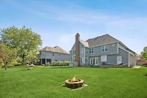 a front view of a house with a garden and yard