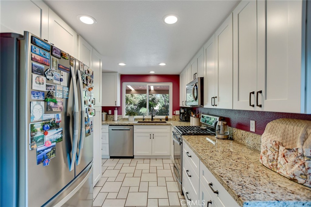 255 Mosport Street Hemet, CA 92544 - Photo 15 of 31 a kitchen with stainless steel appliances granite countertop a refrigerator and a sink