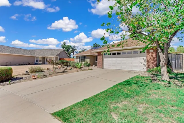 a front view of a house with lots of flower in it