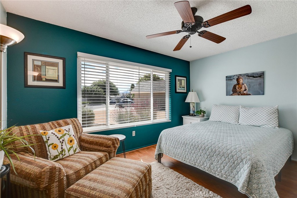 255 Mosport Street Hemet, CA 92544 - Photo 21 of 31 a bedroom with a bed couch and window