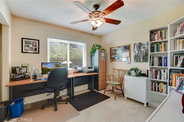 a view of a workspace with a window and lounge chair