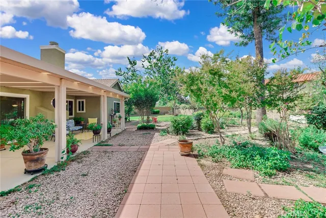a front view of a house with a yard and potted plants