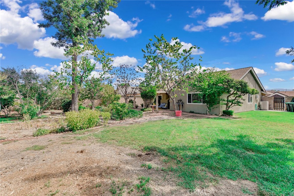 255 Mosport Street Hemet, CA 92544 - Photo 29 of 31 a view of a garden with a building in the background