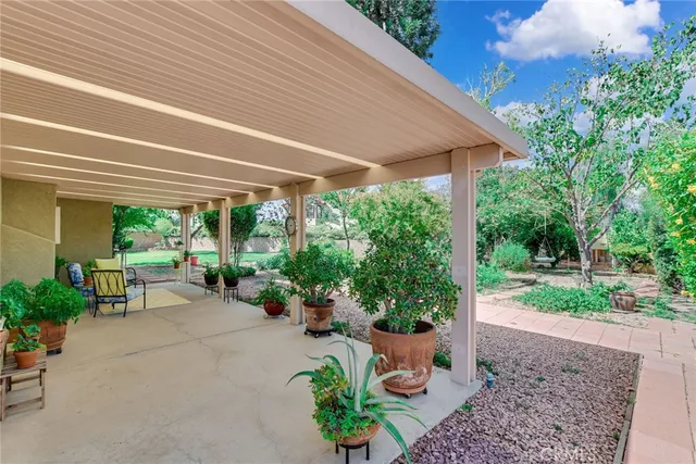 a view of a patio with furniture and garden