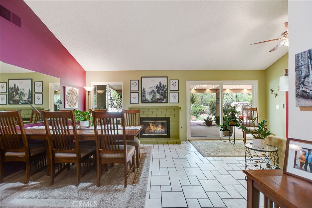 255 Mosport Street Hemet, CA 92544 - Photo 6 of 31 a living room with furniture a fireplace and a floor to ceiling window