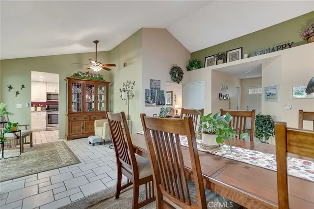 a view of a dining room and livingroom with furniture wooden floor and a chandelier