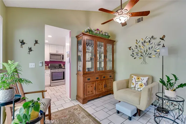 a living room with furniture flowerpot and a potted plant