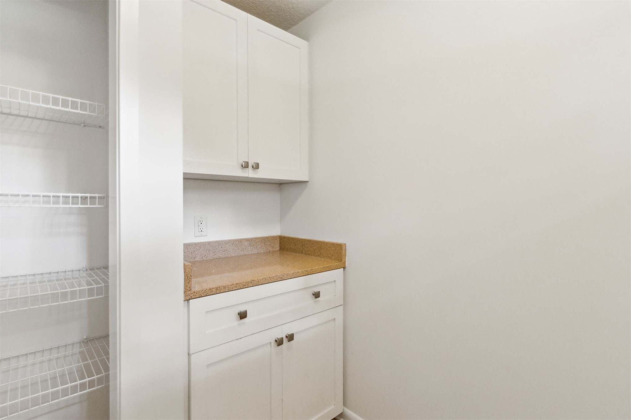 2441 Amelia Road Fernandina Beach, FL 32034 - Photo 31 of 36 a kitchen with white cabinets and a sink