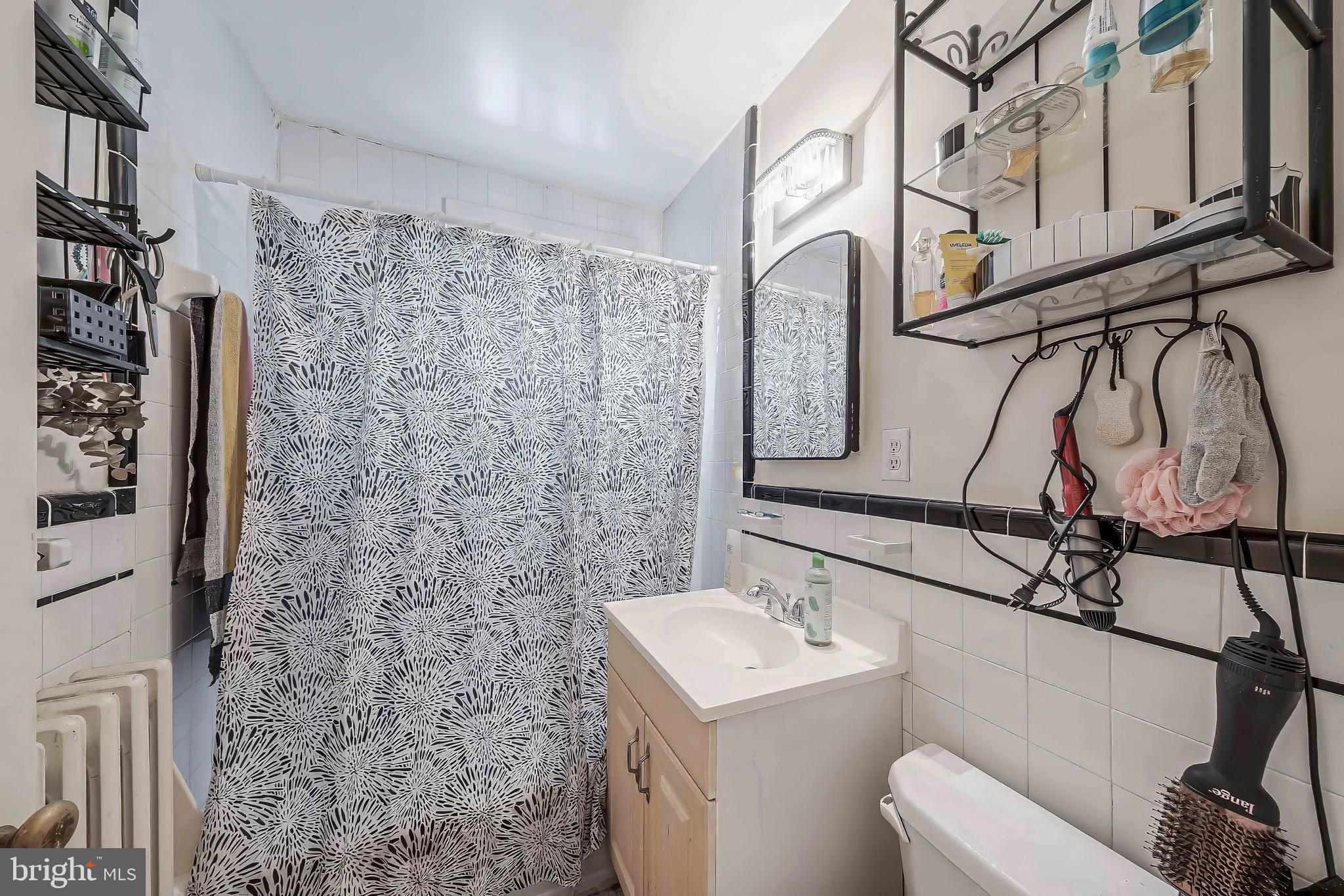 2018 Tunlaw Road Northwest Washington, DC 20007 - Photo 13 of 17 a bathroom with a sink a toilet and shower