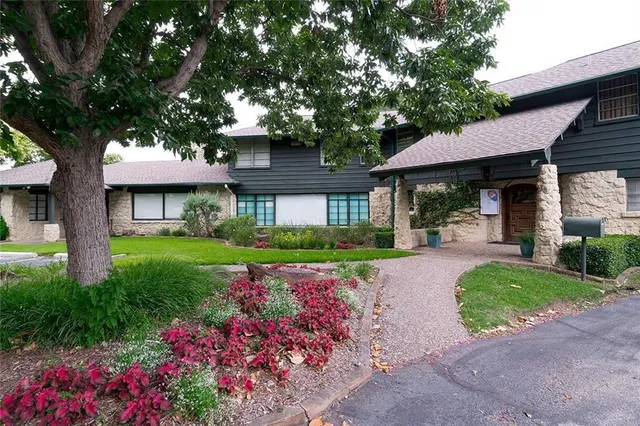 a view of a green field with trees in the background