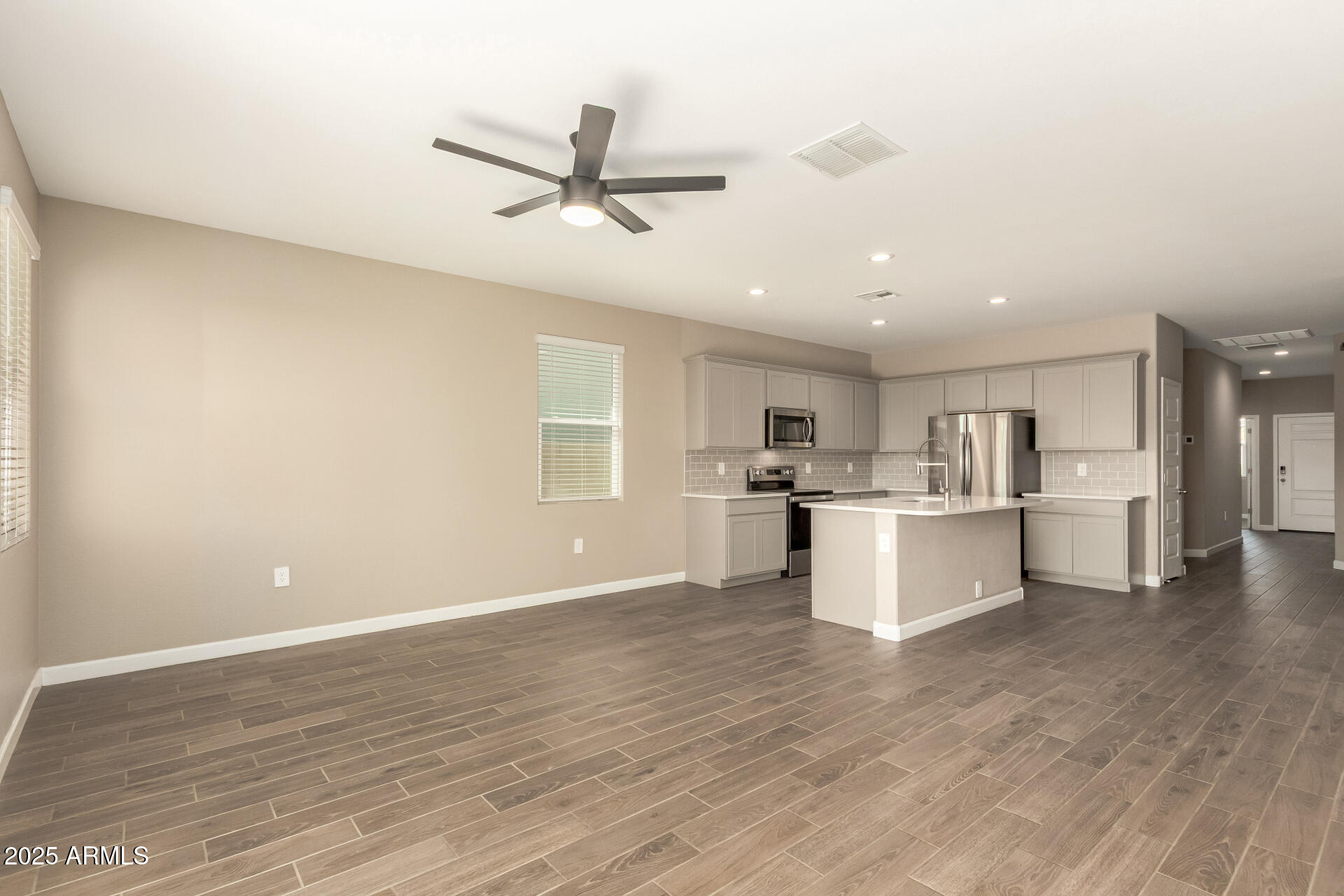 1357 East Chillingham Road San Tan Valley, AZ 85143 - Photo 13 of 32 a view of a kitchen with wooden floor and electronic appliances