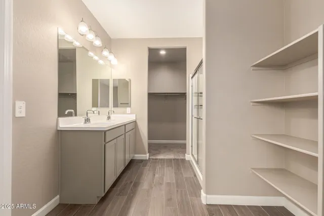 a view of walk in closet with empty racks
