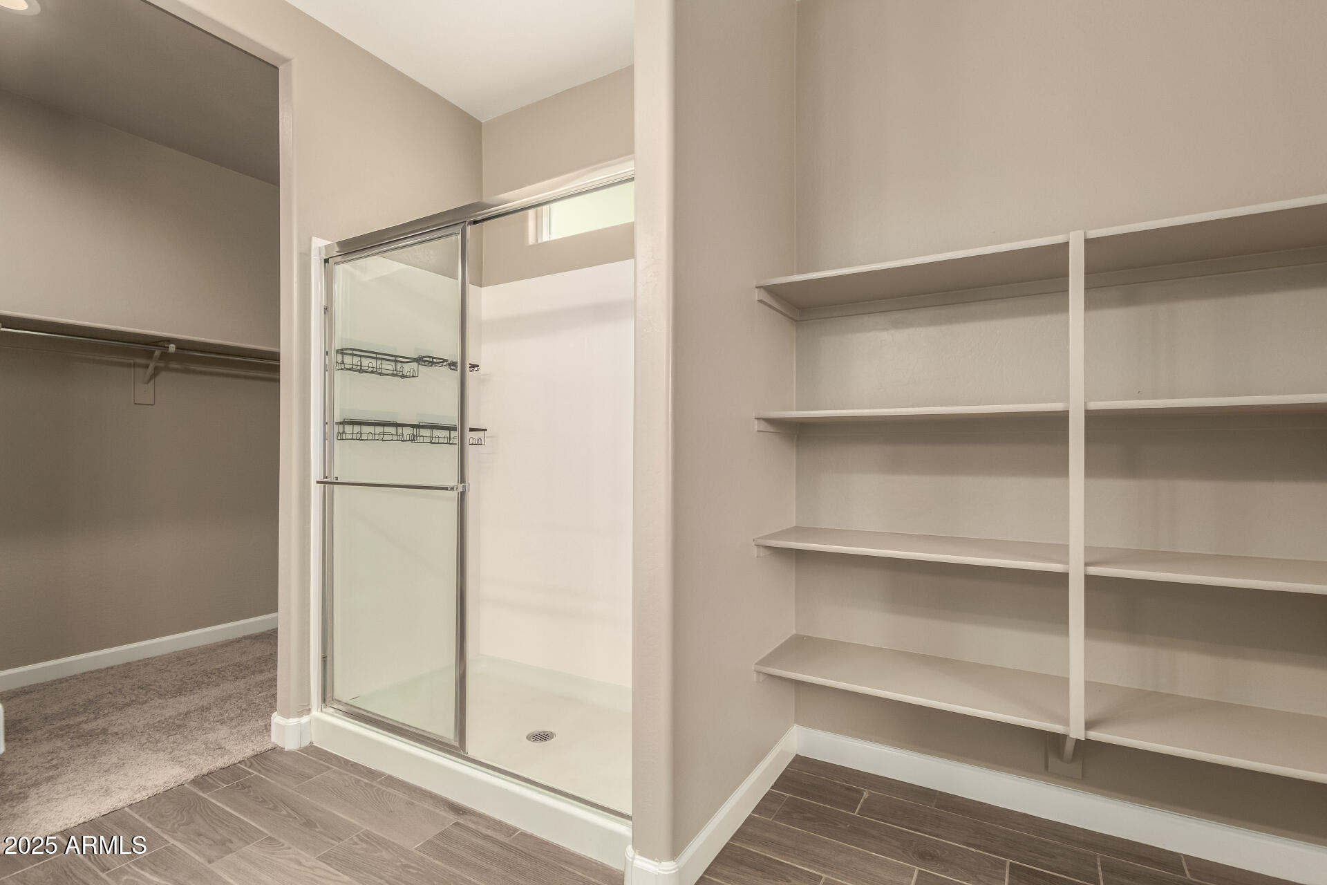 1357 East Chillingham Road San Tan Valley, AZ 85143 - Photo 18 of 32 a view of walk in closet with empty racks