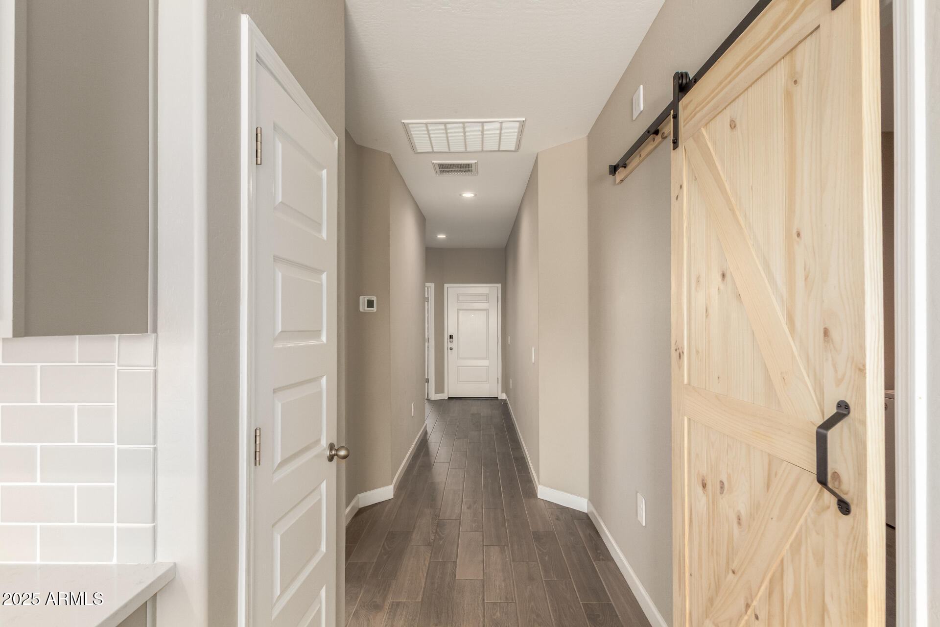 1357 East Chillingham Road San Tan Valley, AZ 85143 - Photo 20 of 32 a view of a hallway with wooden floor and staircase