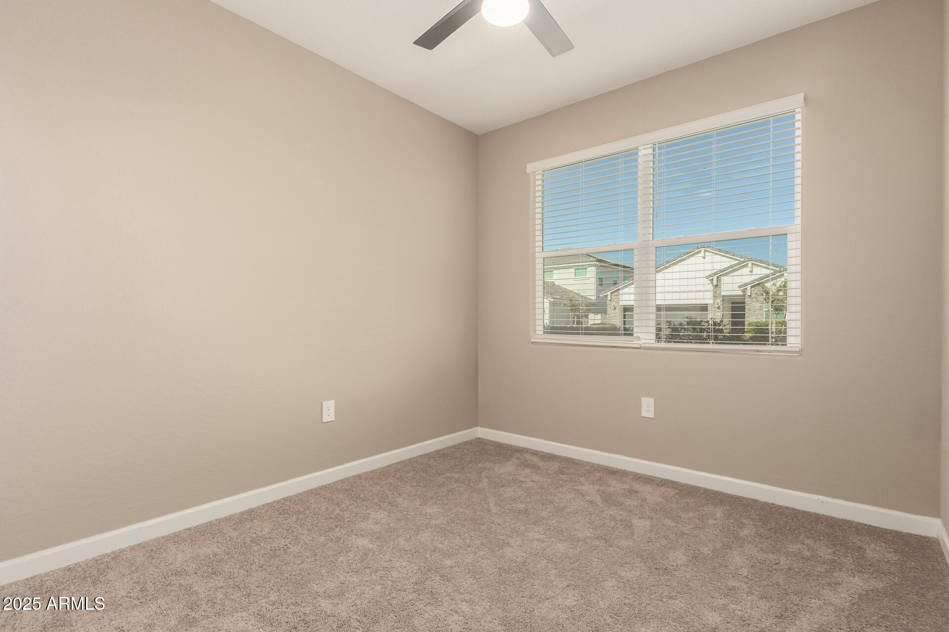 1357 East Chillingham Road San Tan Valley, AZ 85143 - Photo 21 of 32 an empty room with wooden floor and windows