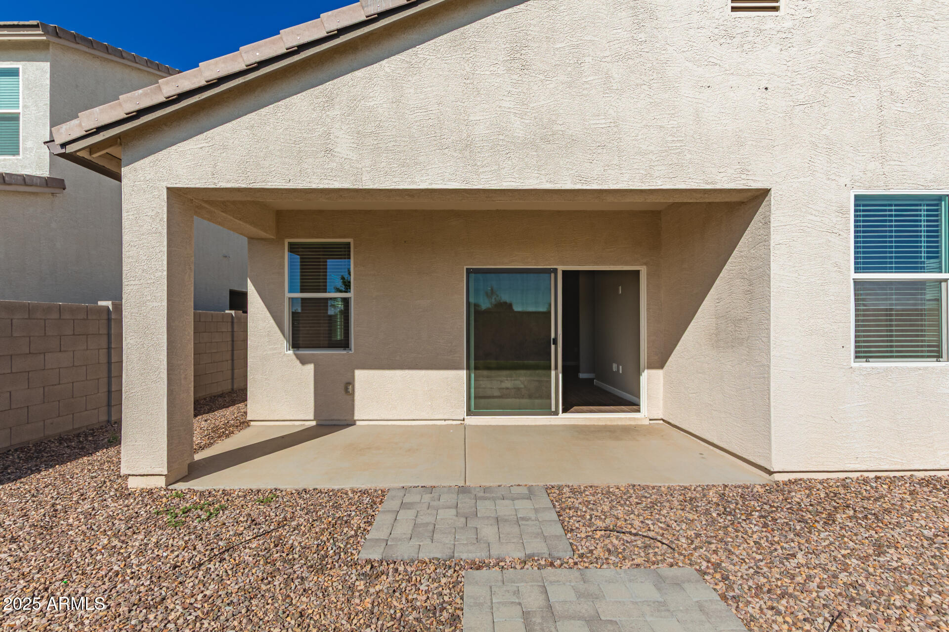1357 East Chillingham Road San Tan Valley, AZ 85143 - Photo 29 of 32 a view of a house with a door and wooden bench