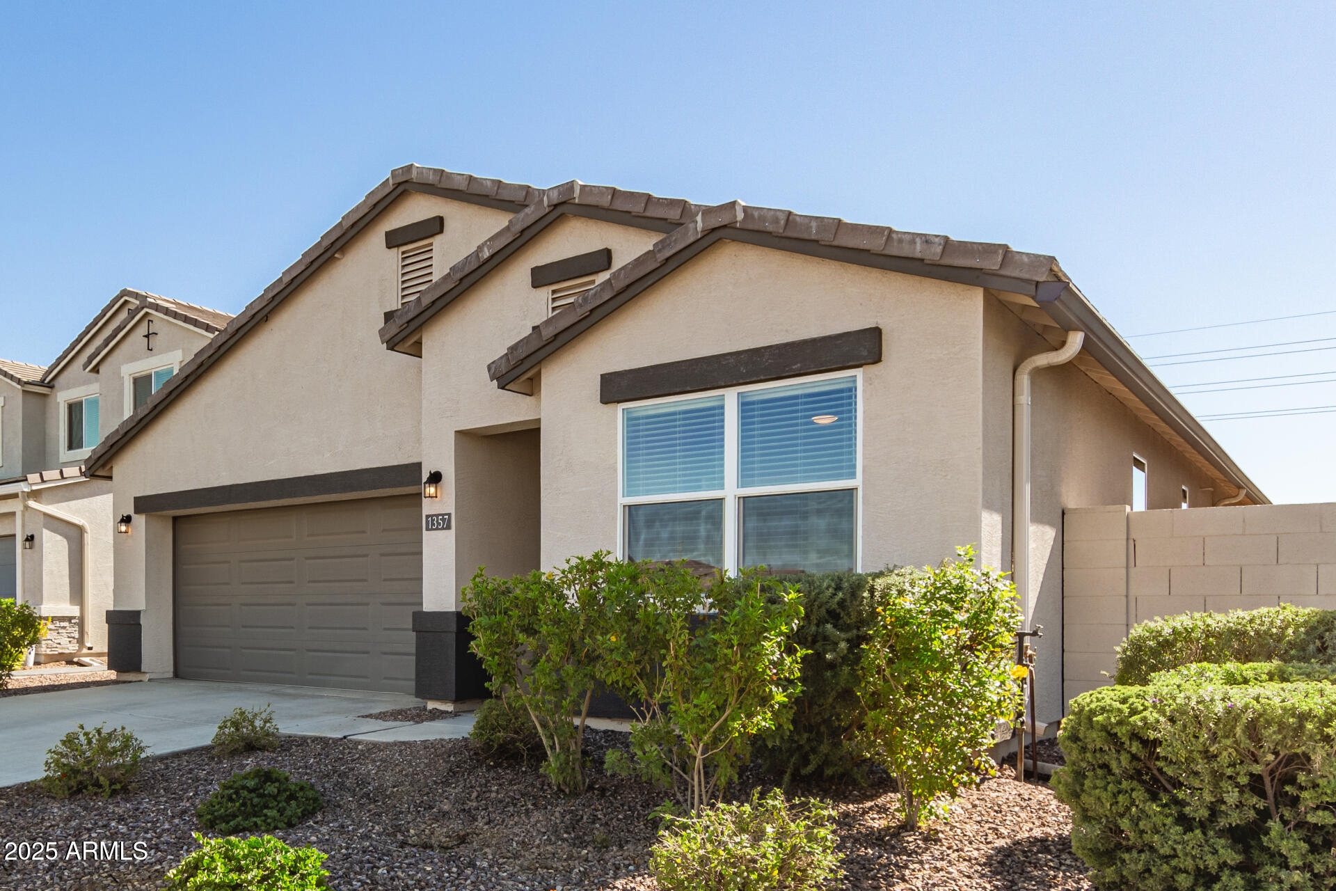 1357 East Chillingham Road San Tan Valley, AZ 85143 - Photo 3 of 32 a front view of a house with garden