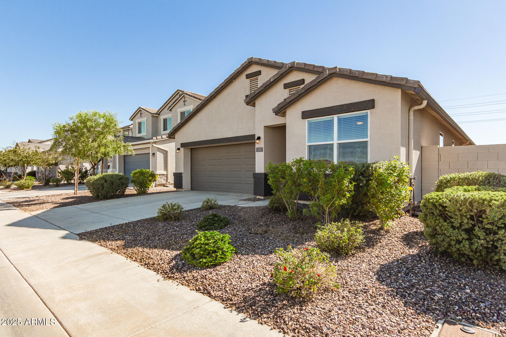 1357 East Chillingham Road San Tan Valley, AZ 85143 - Photo 4 of 32 a front view of a house with a yard and garage