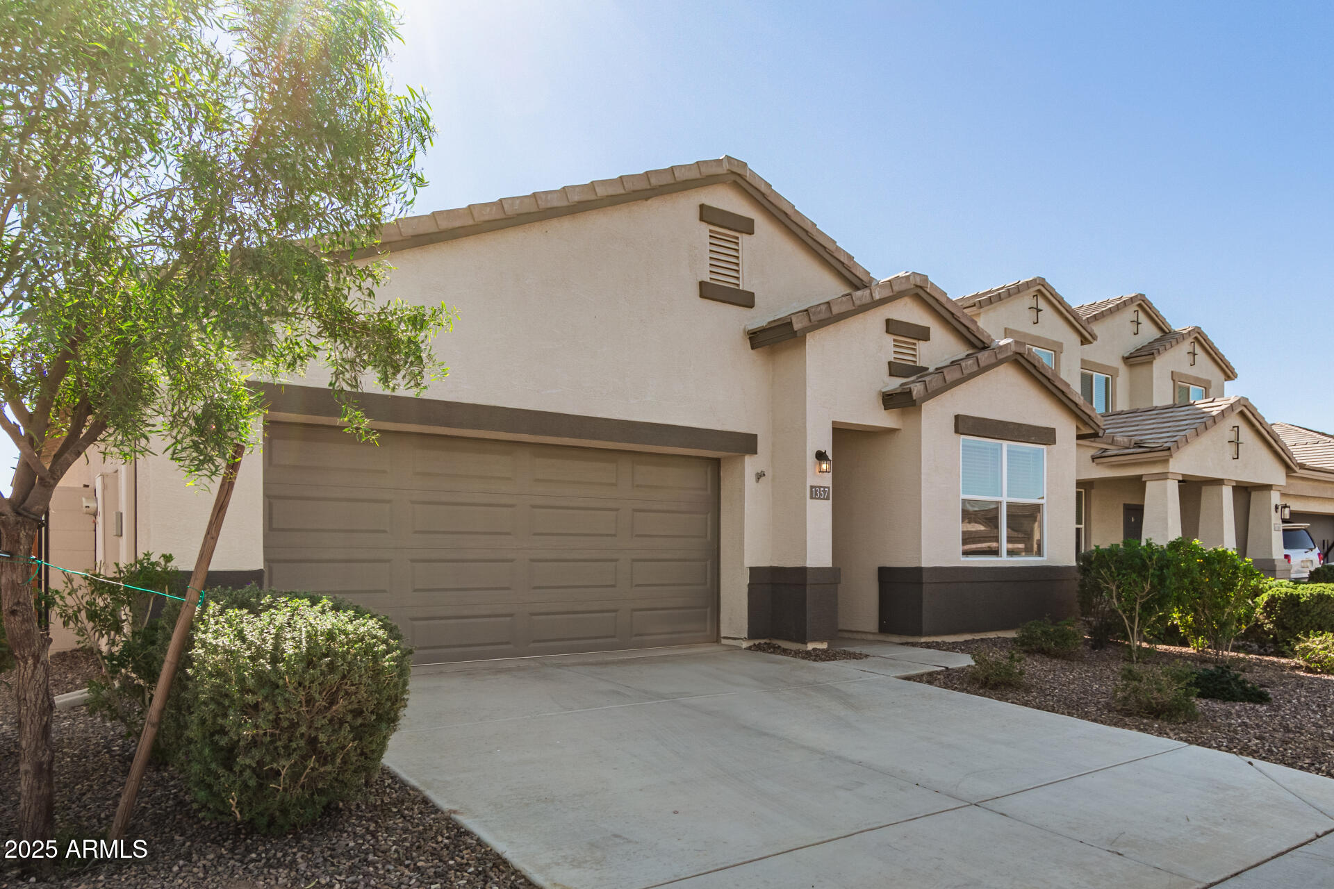 1357 East Chillingham Road San Tan Valley, AZ 85143 - Photo 5 of 32 a front view of a house with a yard and garage