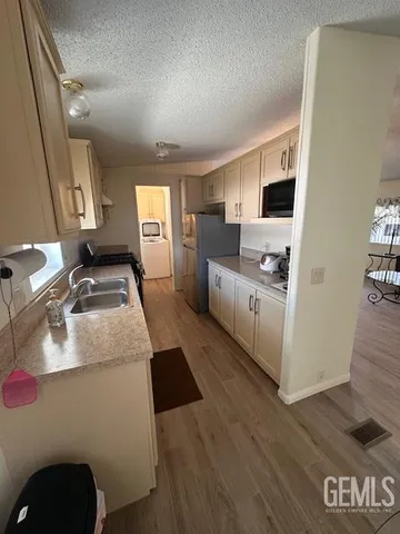 a kitchen with sink refrigerator and stove