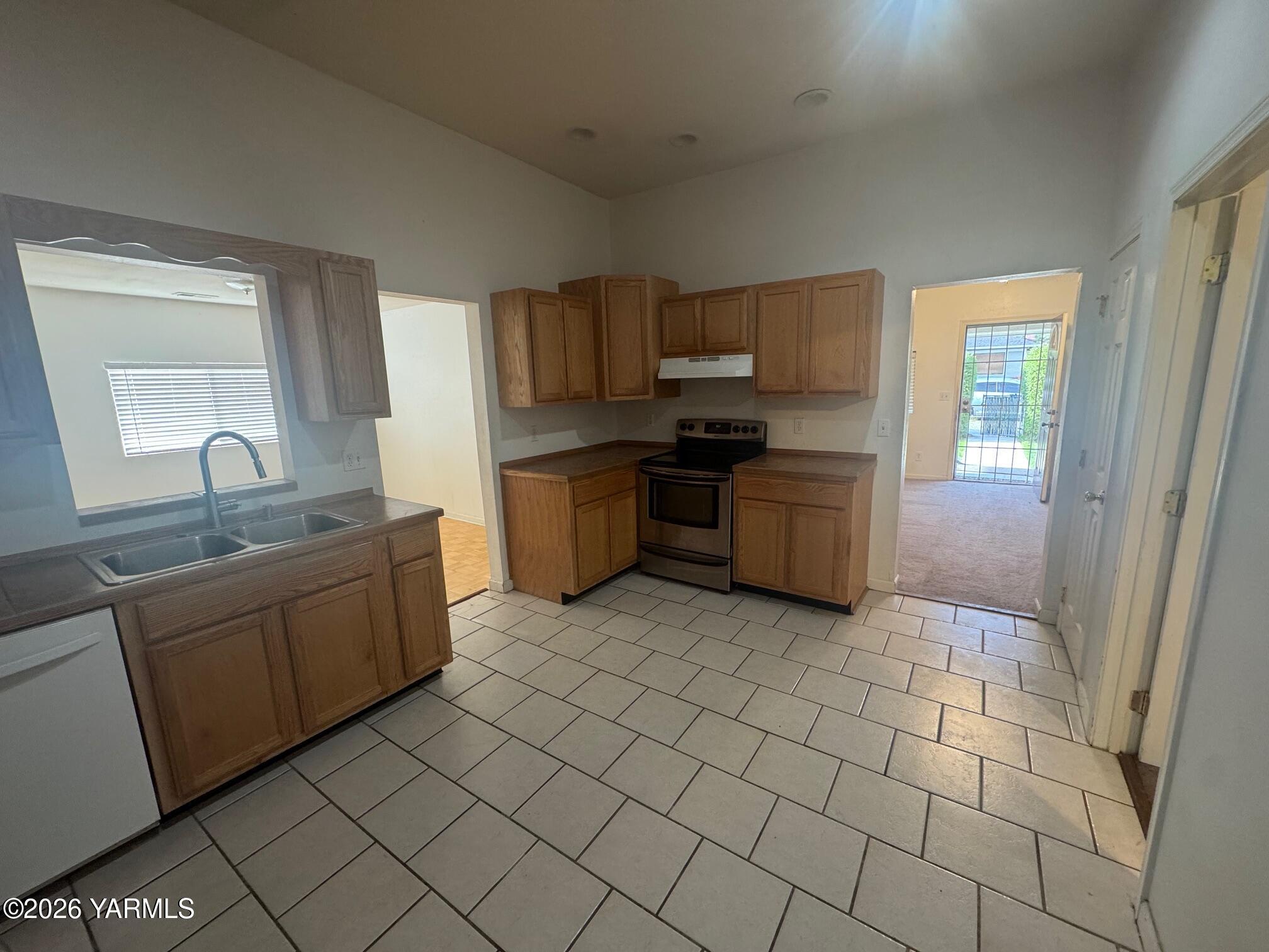 110 East Second Street Naches, WA 98937 - Photo 6 of 17 a kitchen with stainless steel appliances granite countertop a sink and cabinets