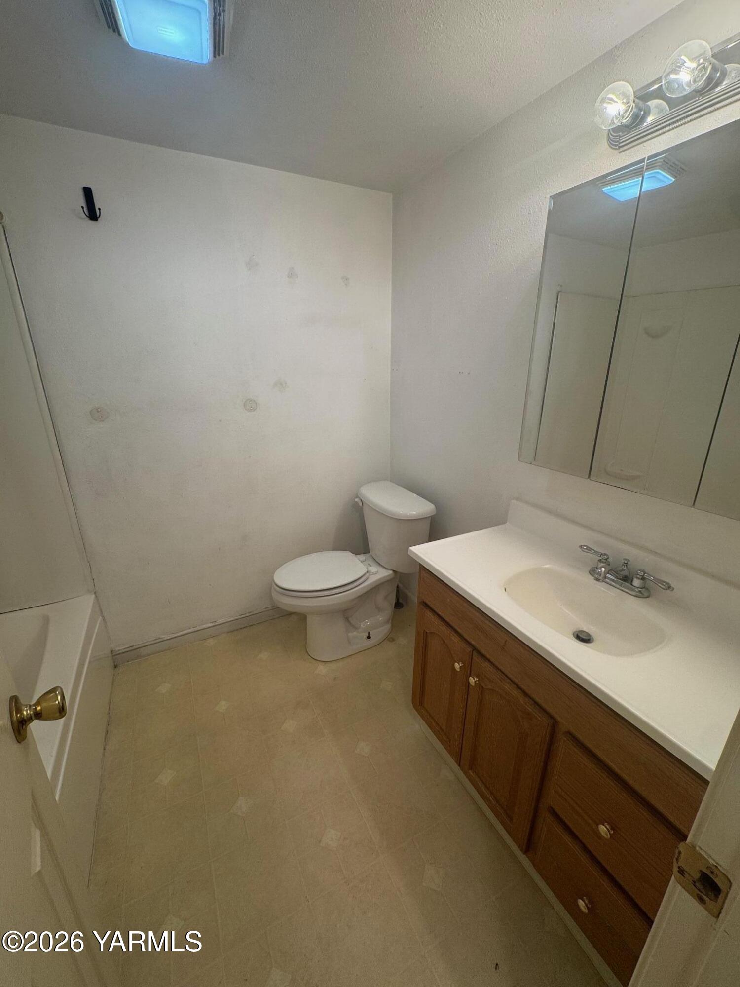 110 East Second Street Naches, WA 98937 - Photo 9 of 17 a bathroom with a sink a toilet and a mirror