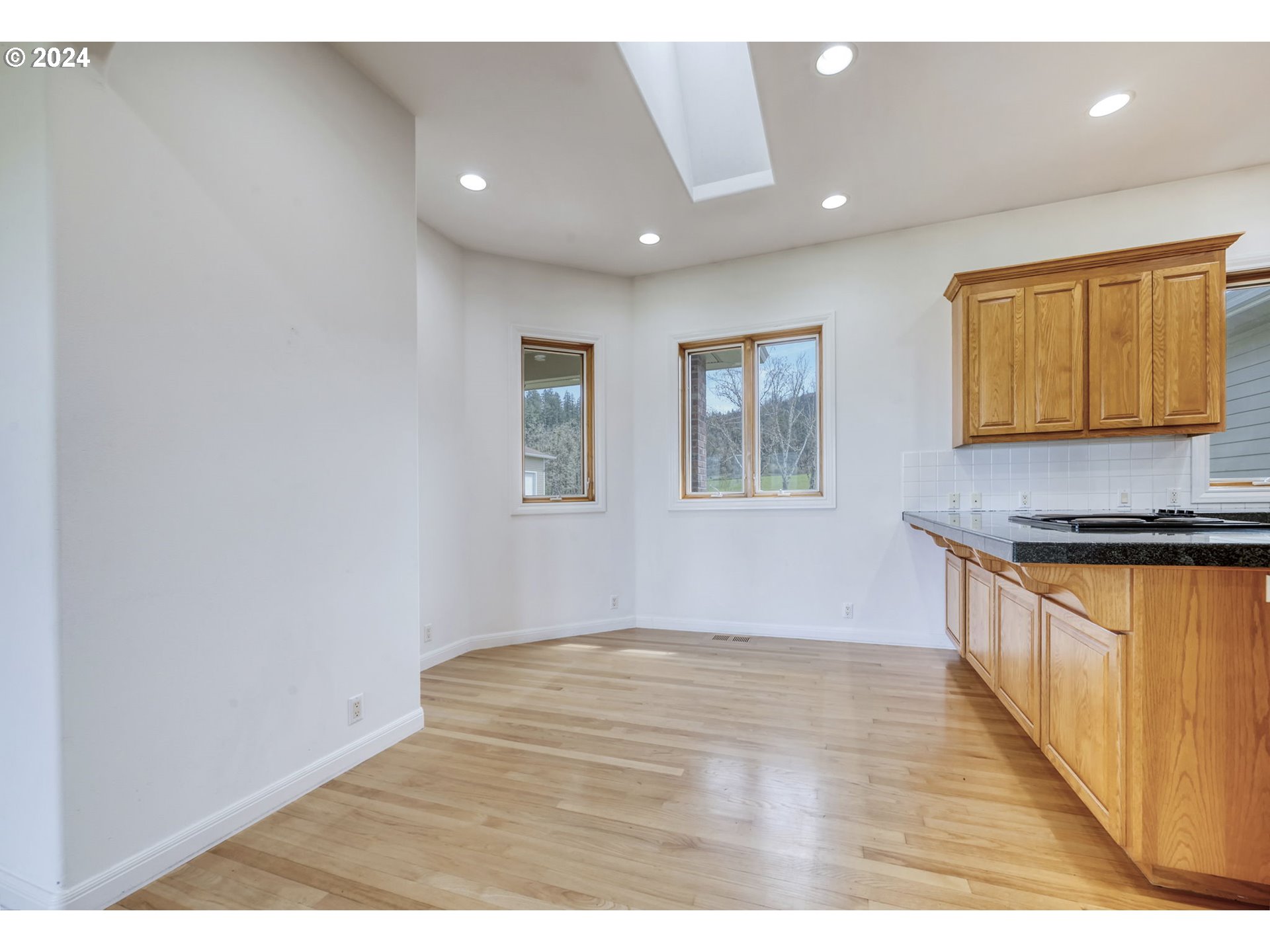 35741 Spring Hill Road Creswell, OR 97426 - Photo 12 of 47 a view of an empty room with window and wooden floor