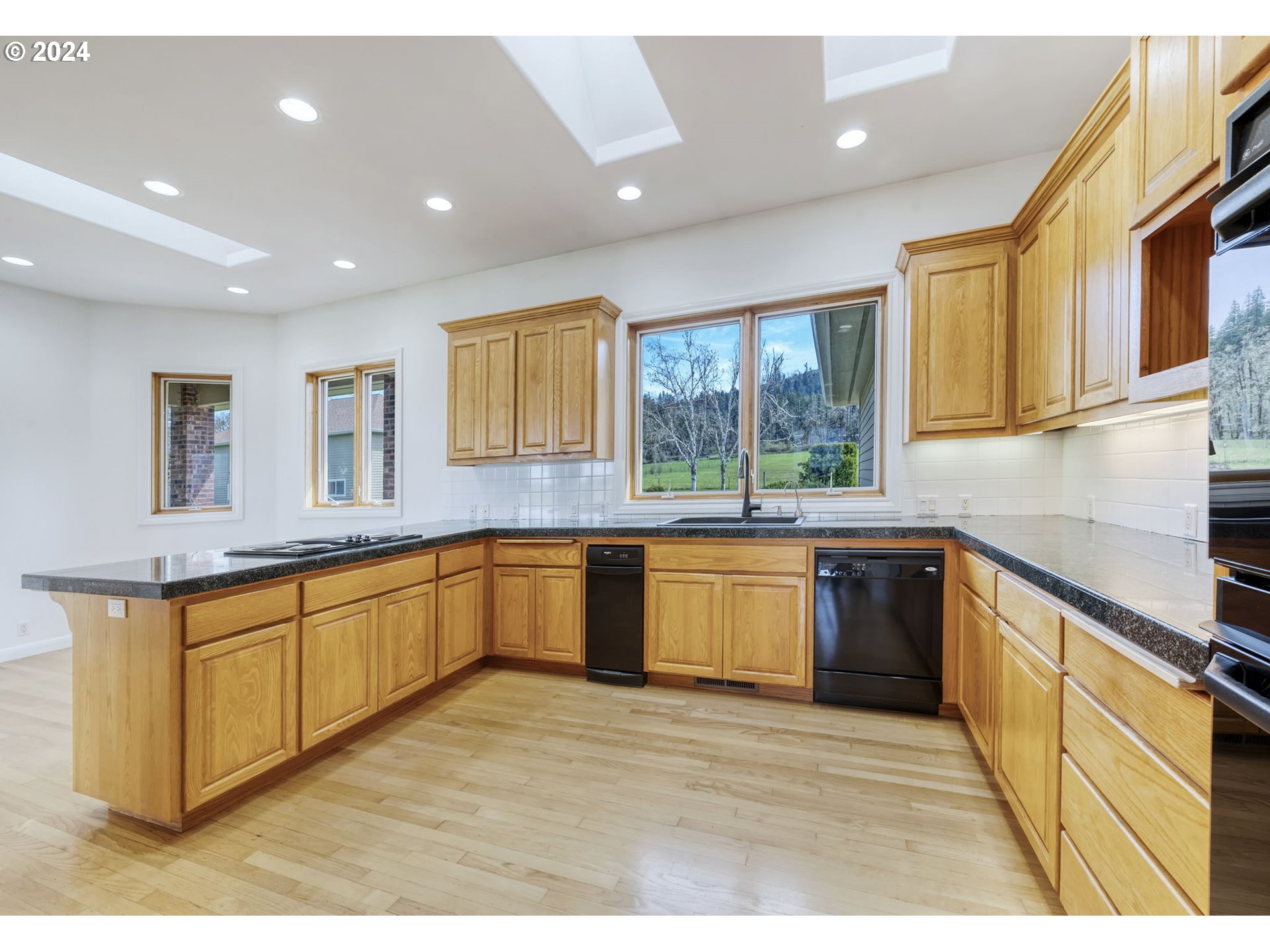 35741 Spring Hill Road Creswell, OR 97426 - Photo 14 of 47 a large kitchen with stainless steel appliances granite countertop a sink and wooden cabinets
