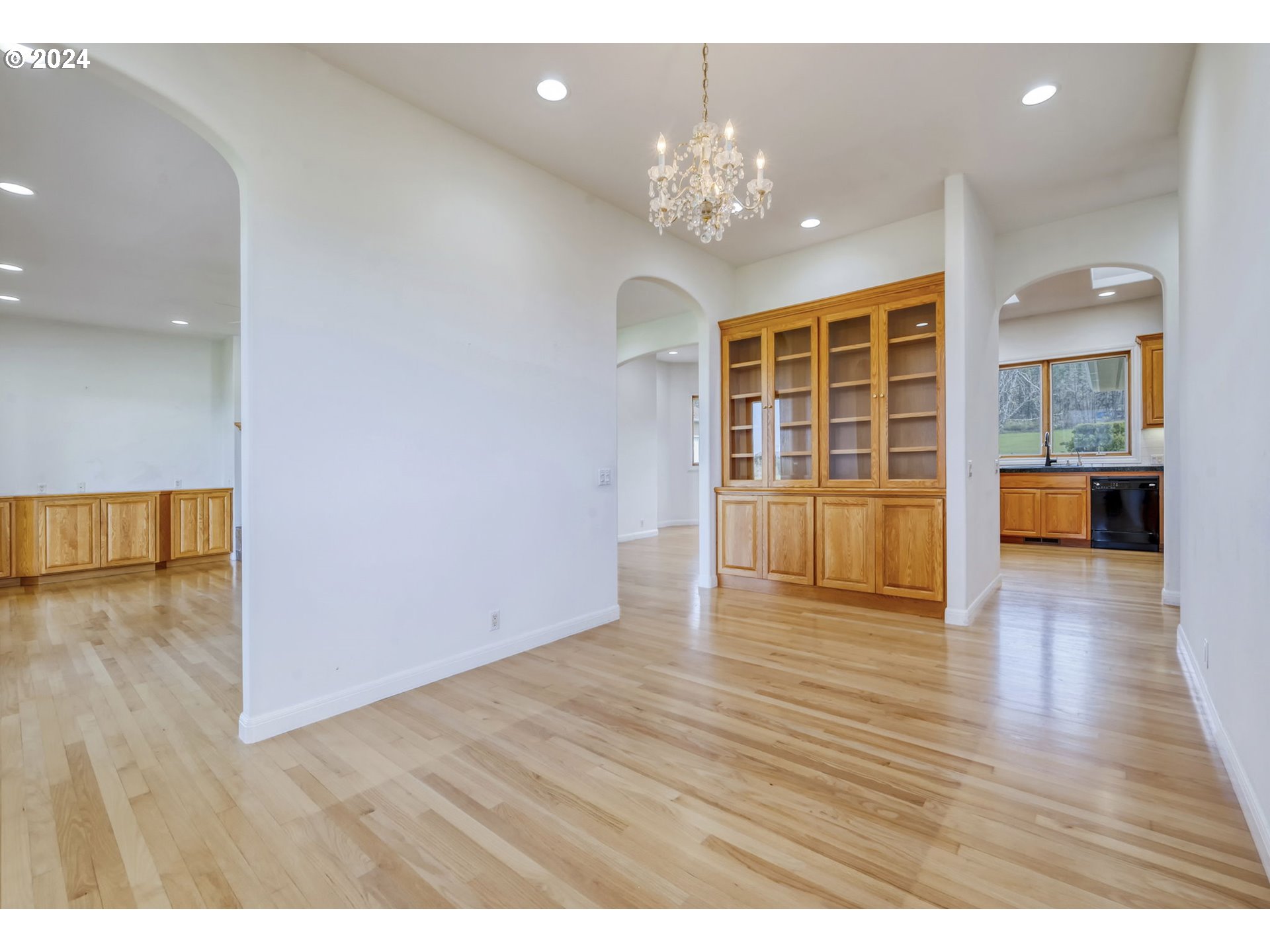 35741 Spring Hill Road Creswell, OR 97426 - Photo 18 of 47 a view of an empty room with wooden floor and a kitchen