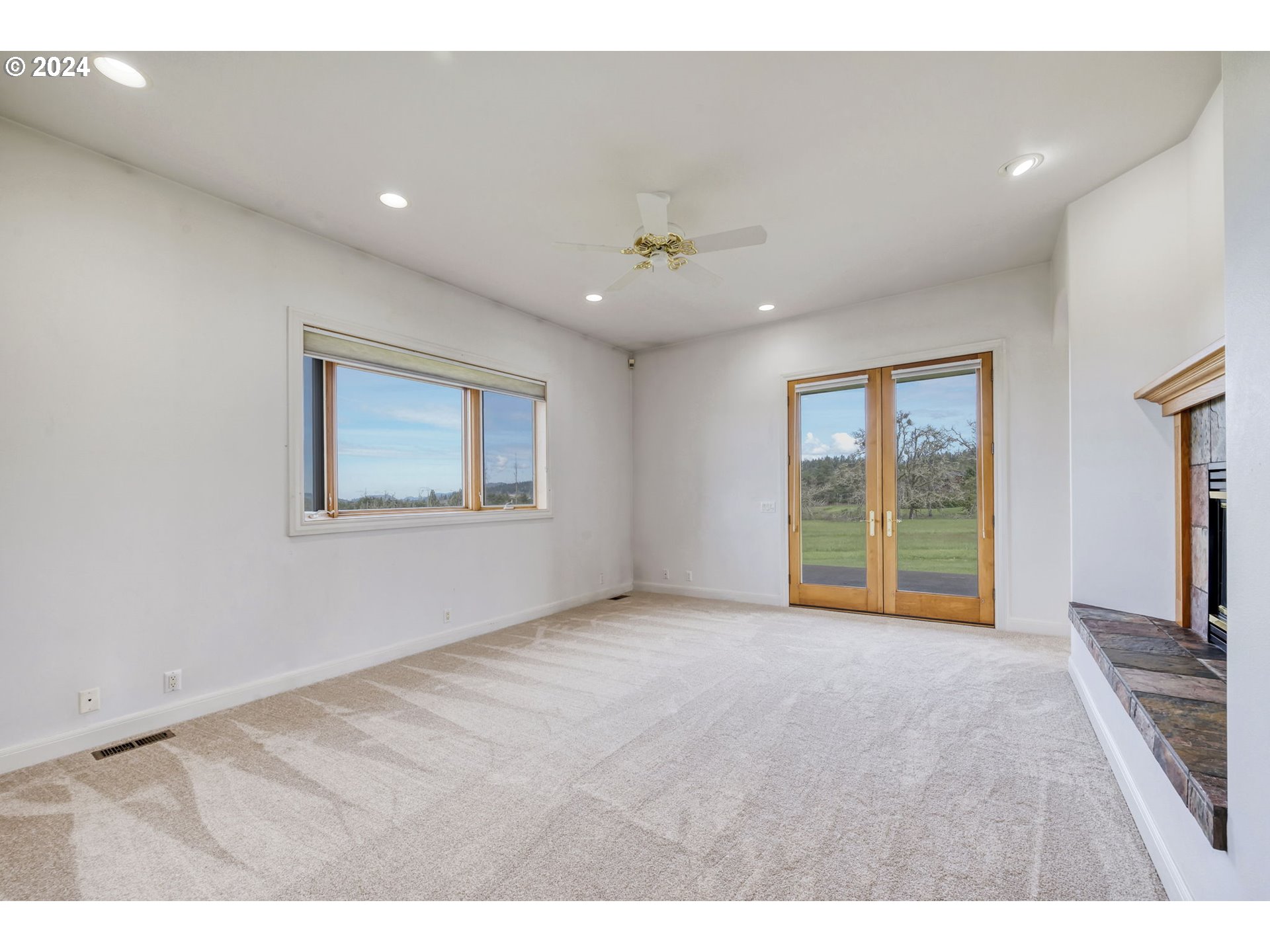 35741 Spring Hill Road Creswell, OR 97426 - Photo 21 of 47 a view of an empty room with a window and a kitchen