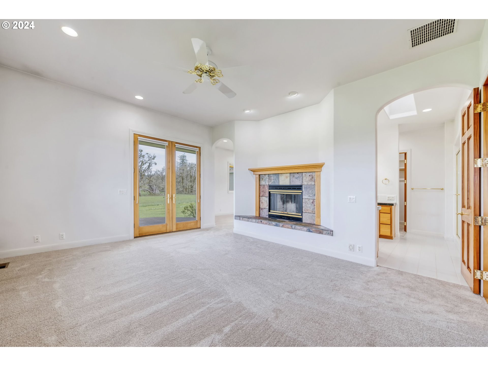 35741 Spring Hill Road Creswell, OR 97426 - Photo 22 of 47 a view of an empty room with a fireplace and a window