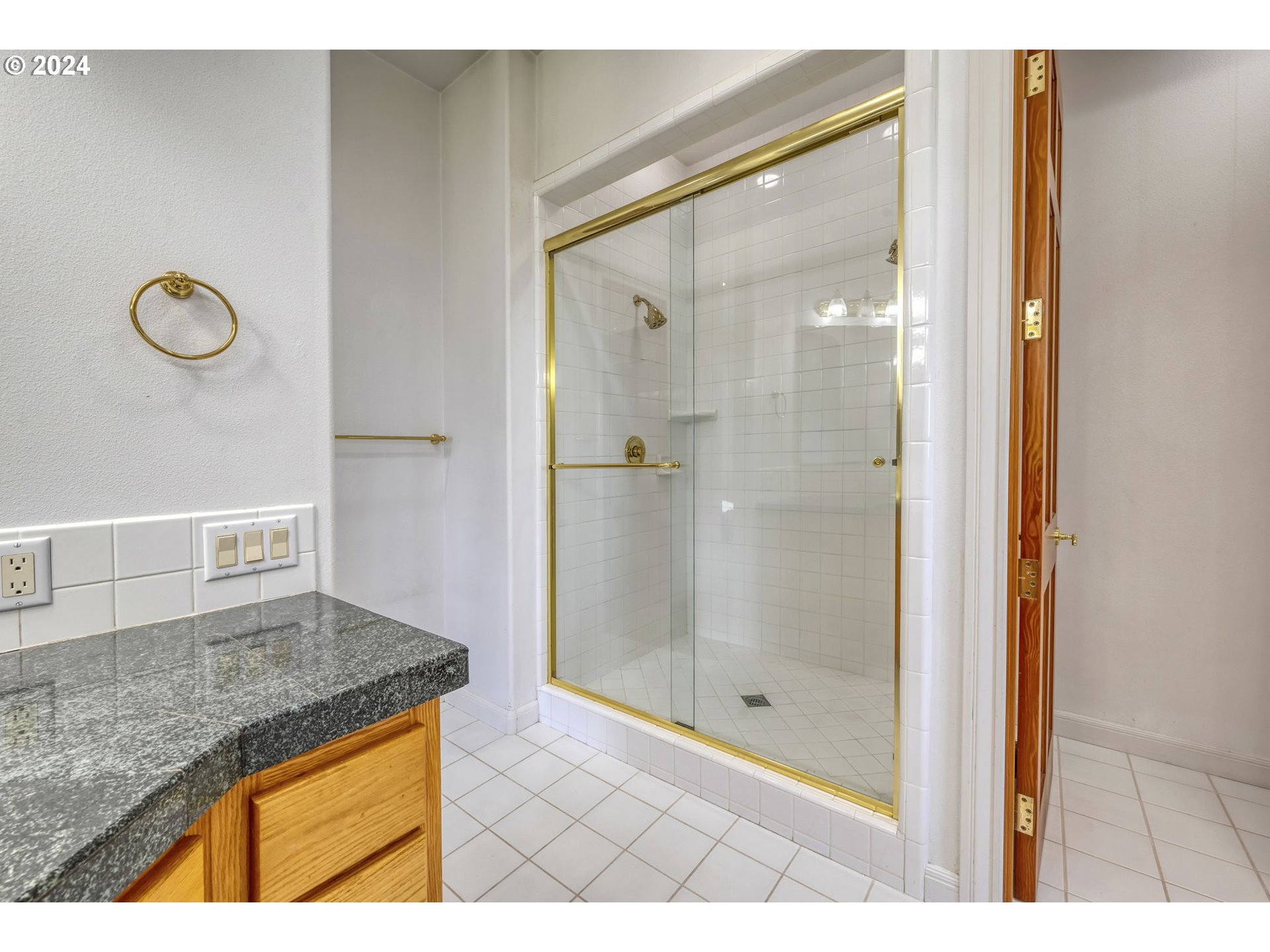 35741 Spring Hill Road Creswell, OR 97426 - Photo 27 of 47 a bathroom with a granite countertop sink a mirror and shower