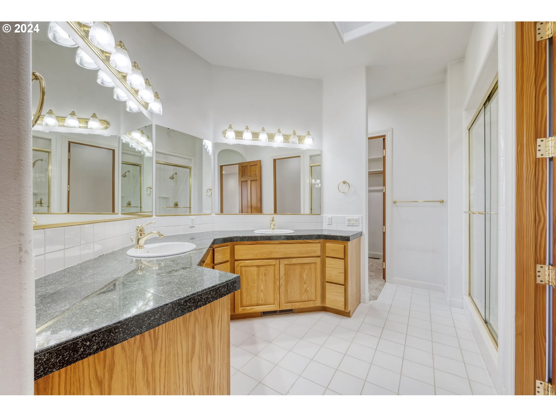 35741 Spring Hill Road Creswell, OR 97426 - Photo 29 of 47 a bathroom with a granite countertop sink a mirror and a bathtub