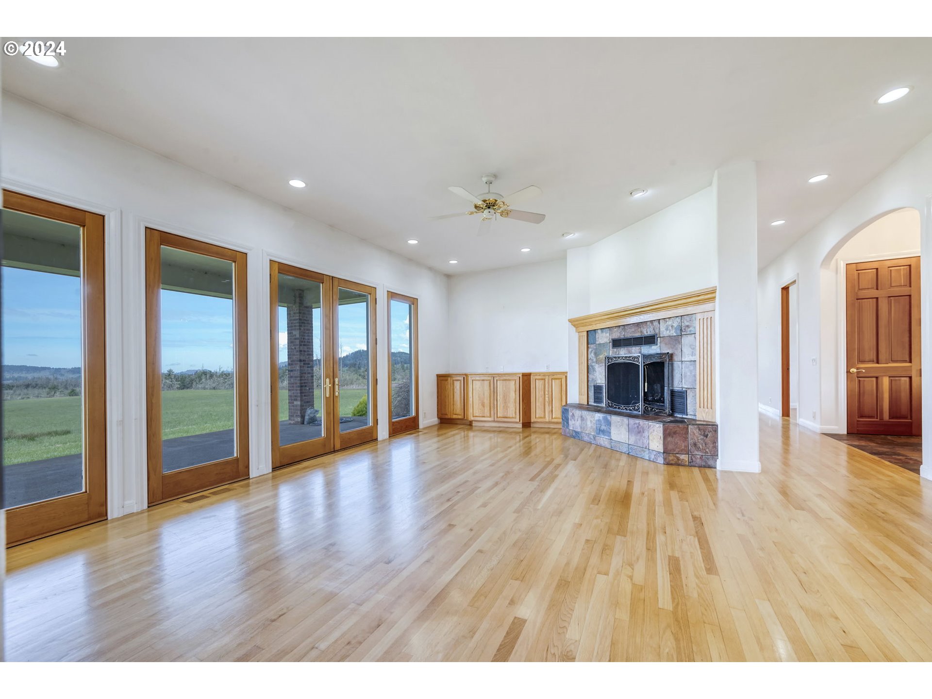 35741 Spring Hill Road Creswell, OR 97426 - Photo 7 of 47 a view of an empty room with wooden floor and a fireplace