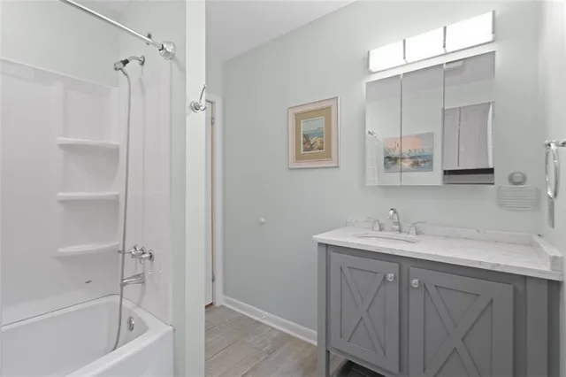 a bathroom with a tub sink a mirror and a shower