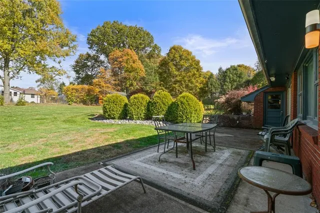 a view of a backyard with sitting area