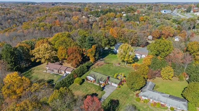 an aerial view of house with yard and mountain view in back