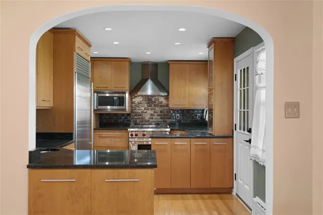 a kitchen with stainless steel appliances granite countertop a sink and cabinets