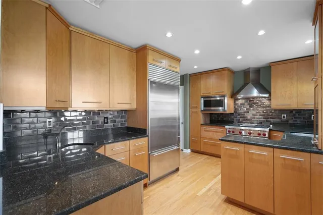 a kitchen with kitchen island granite countertop a sink and counter space